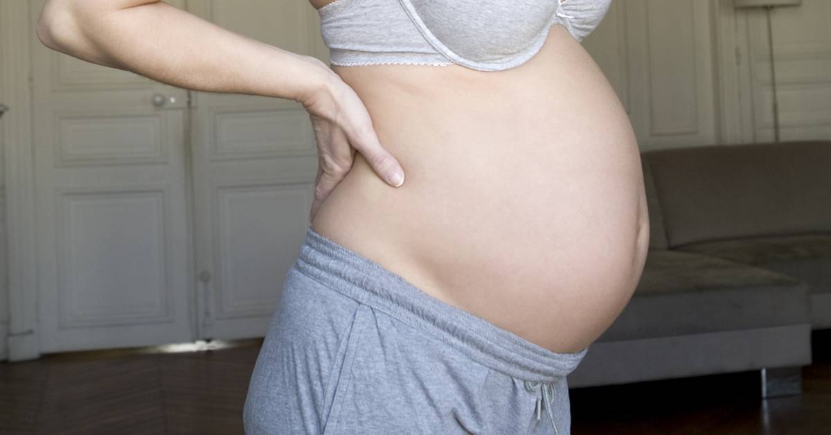 Почему может болеть живот в начале беременности?